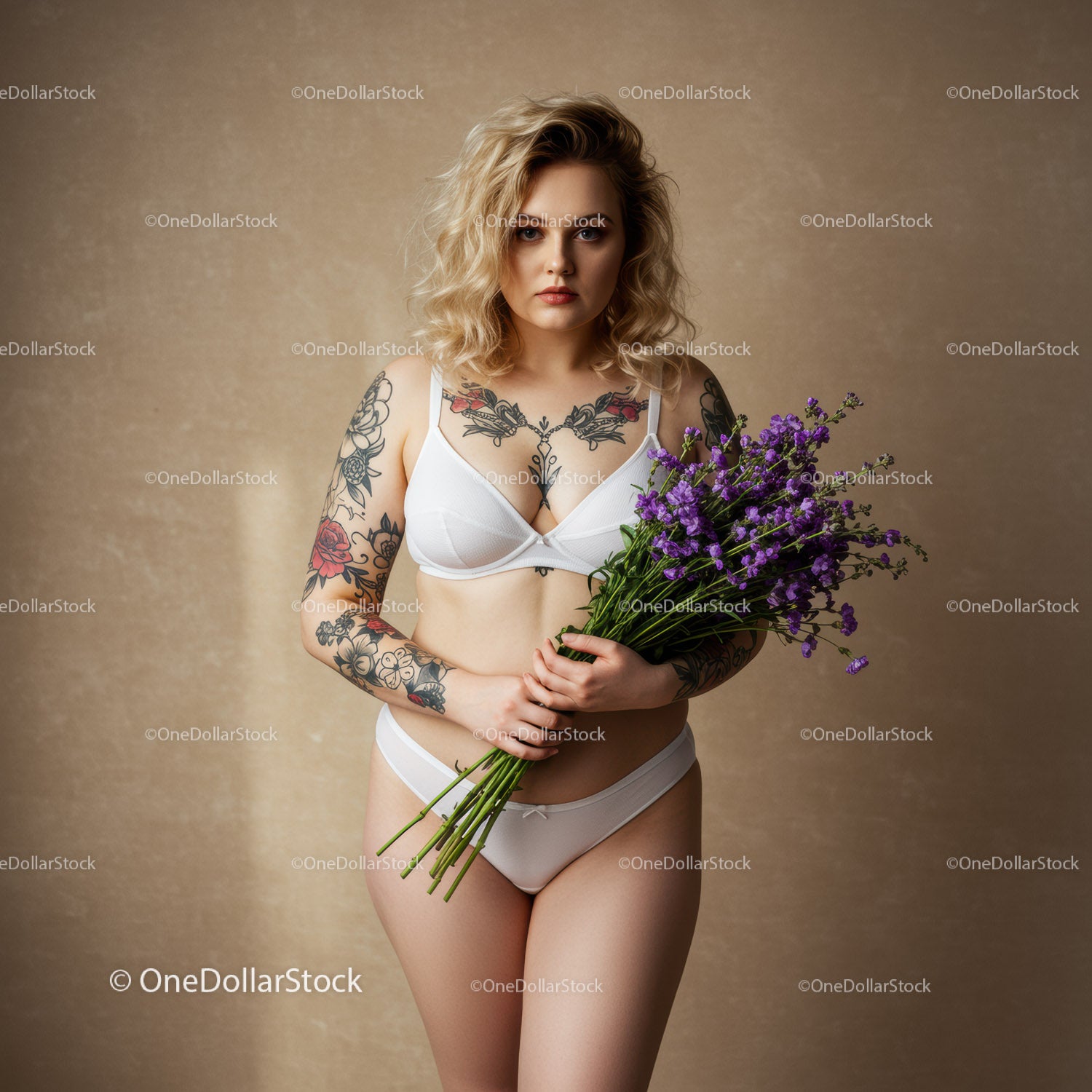 Tattooed Woman Holding Purple Flower Bouquet in Elegant Studio Portrait