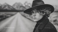 Black and White Portrait of Woman Wearing Wide-Brimmed Hat in Outdoors