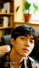 Young man with thoughtful gaze in cozy indoor setting