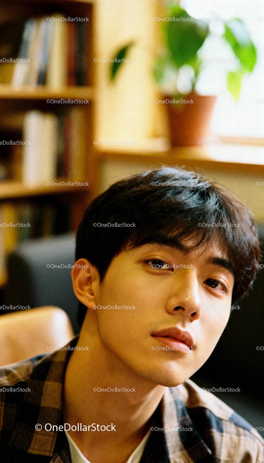 Young man with thoughtful gaze in cozy indoor setting