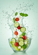 Fresh vegetable salad splash in glass bowl