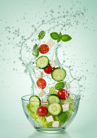 Fresh vegetable salad splash in glass bowl