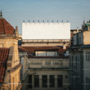 Empty Billboard Above Historic City Rooftops in Soft Light