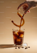 Pouring Cold Brew Coffee Over Ice Cubes