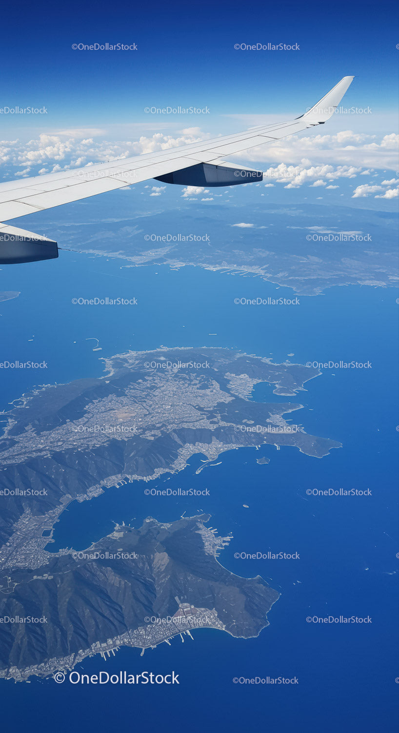 Aerial View of Coastline and Mountains From Airplane Window