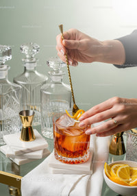 Elegant Amber Cocktail with Citrus Garnish in Stylish Glass
