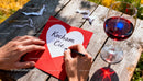 Writing a heartfelt love note on a picnic table outdoors