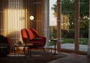Cozy reading nook with warm lighting near glass doors