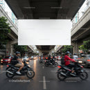 Busy Urban Street with Motorcycles and Traffic Under Overpass