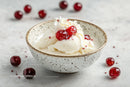 Creamy Vanilla Ice Cream with Cherry Topping in a Ceramic Bowl