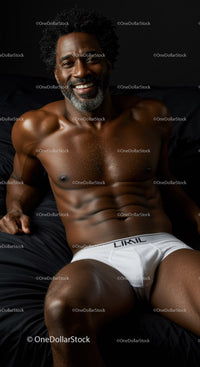 Smiling muscular man relaxing on black bed in white underwear