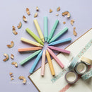 Pastel crayons arranged in circle with decorative tapes