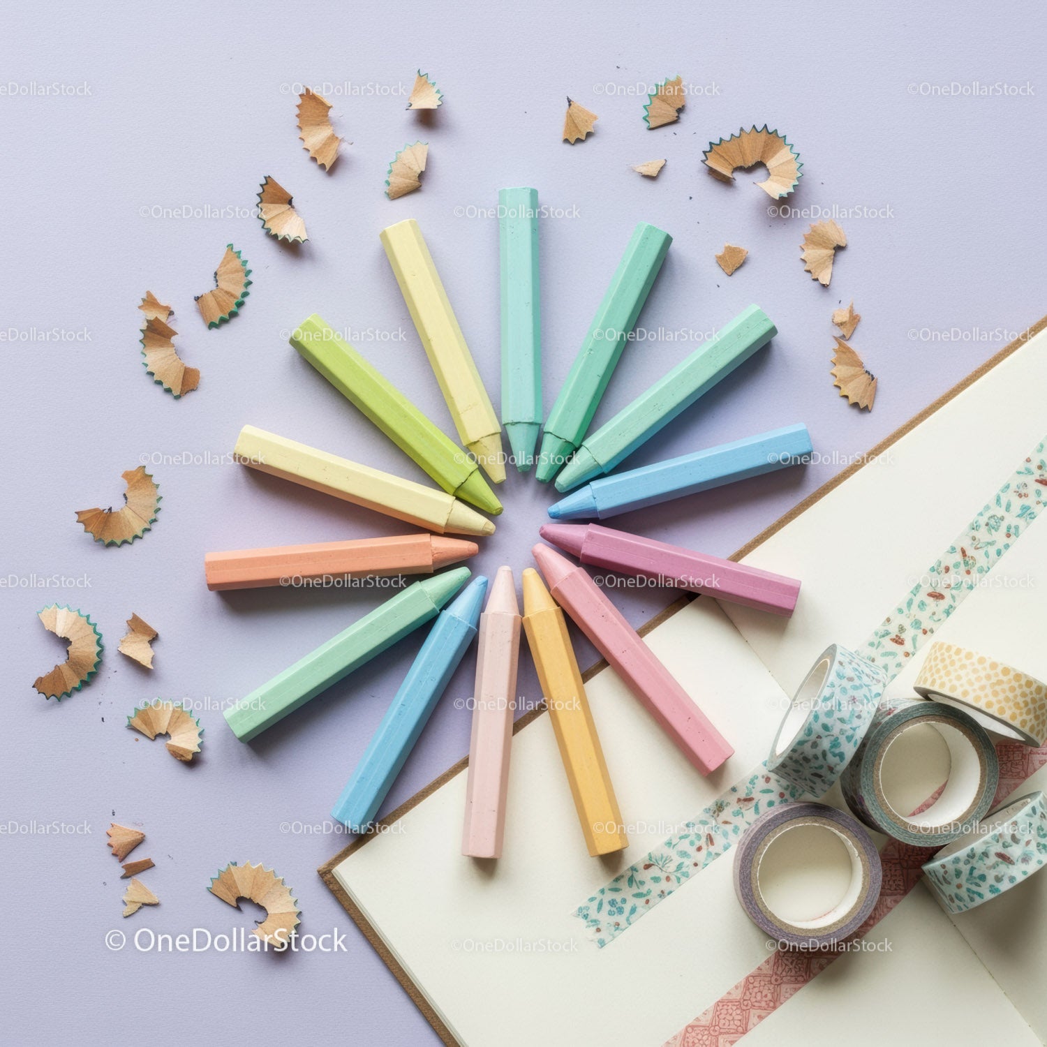 Pastel crayons arranged in circle with decorative tapes