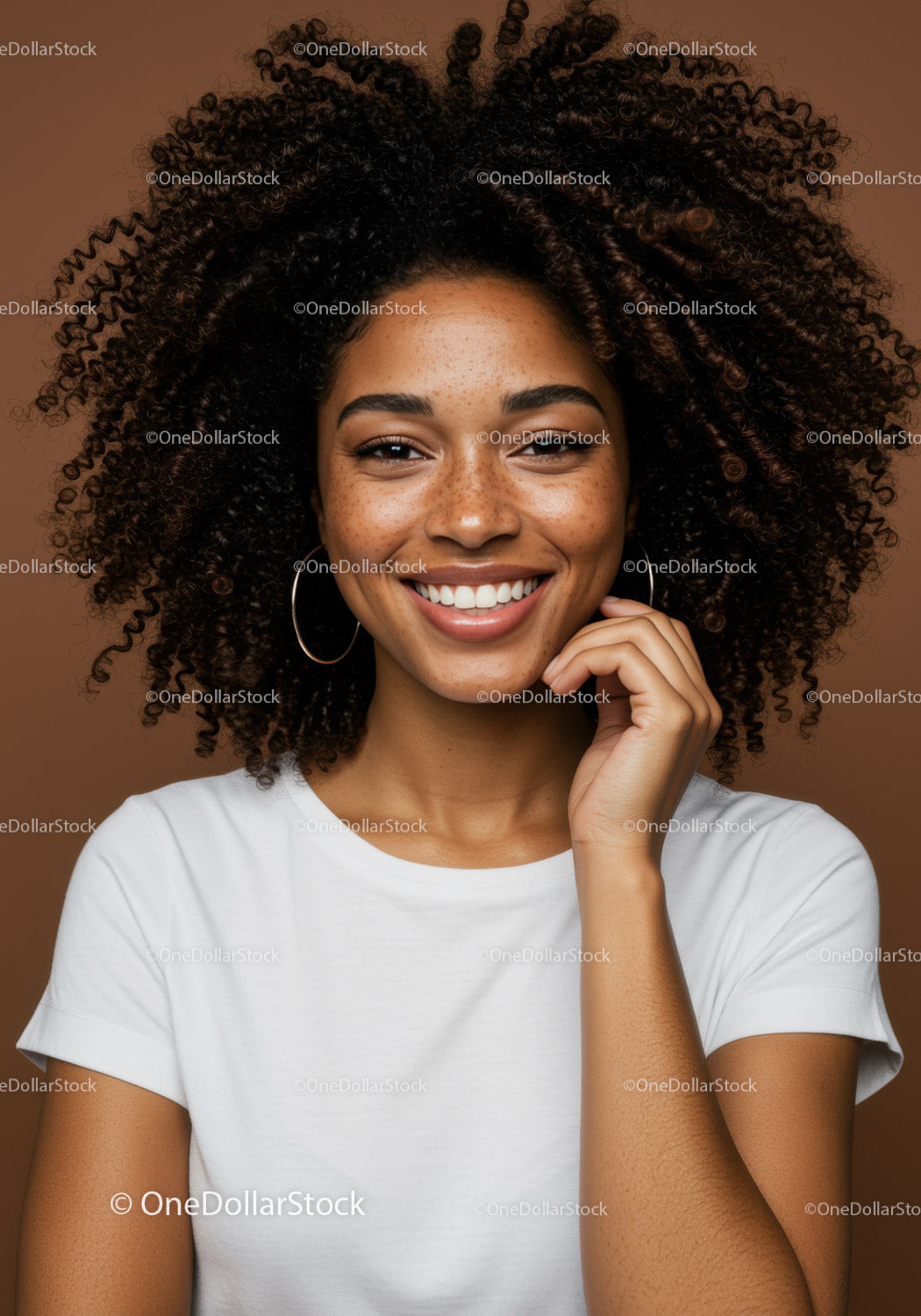 Portrait of a Smiling Woman with Curly Hair and Freckles in a Studio
