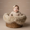 Adorable Baby Girl Sitting in Cozy Basket with Fur