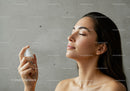 Relaxed Woman Applying Facial Hydration Spray for Healthy Skin