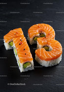 Fresh salmon sushi arranged into number 18 on slate