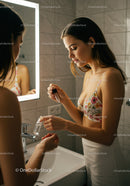 Young Woman Applying Hand Sanitizer in Modern Bathroom
