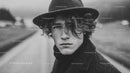 Stylish Young Man in Raincoat and Hat on Urban Street