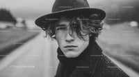 Stylish Young Man in Raincoat and Hat on Urban Street
