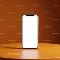 Modern smartphone with blank screen on orange table
