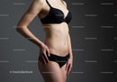 Elegant Woman in Black Lingerie with Tattooed Body on Gray Background