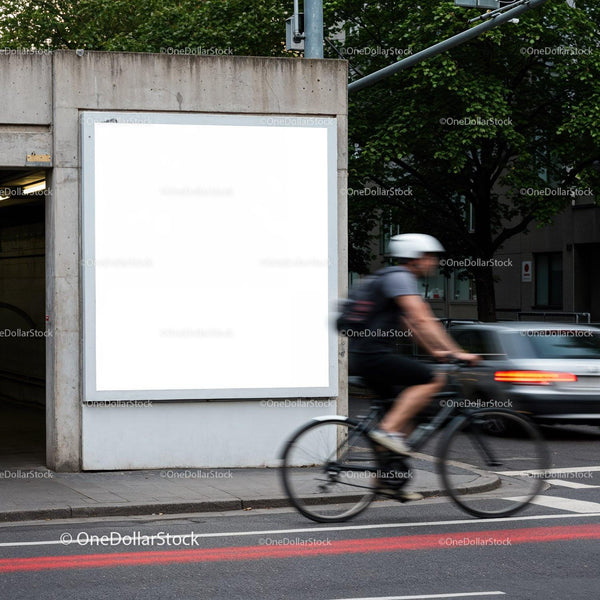 Cyclist passing by blank urban billboard on city street JPG Mockup Image