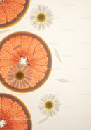 Fresh grapefruit slices with delicate chamomile flowers