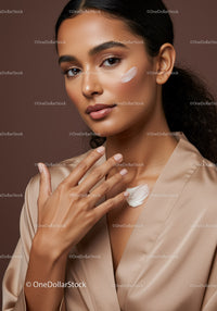 Elegant Woman Applying Facial Cream for Skincare Routine