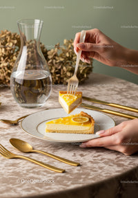 Lemon Cheesecake Slice with Lemon Slices and Gold Cutlery