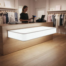 Modern clothing store checkout counter with glowing panel