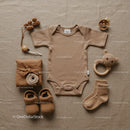 Neutral toned baby essentials styled flat lay