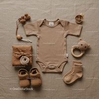 Neutral toned baby essentials styled flat lay
