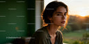 Thoughtful young woman bathed in warm sunset light