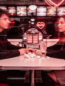 Couple Holding Hands in Retro Diner with Neon Heart