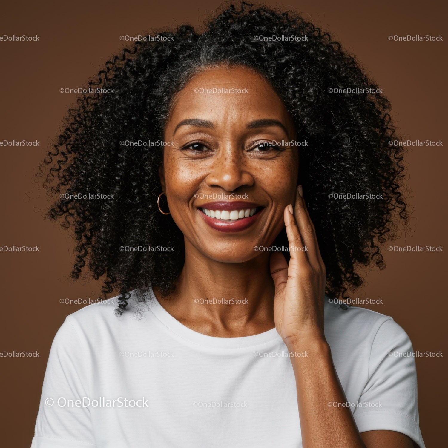 Confident Smiling Woman with Curly Hair in Casual White T-Shirt