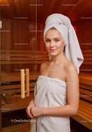 Young Woman Relaxing in Sauna with Towel Wrapped Hair