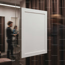 Blank white canvas hanging in modern gallery space