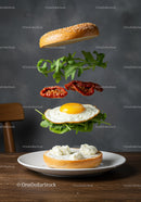Deconstructed breakfast bagel with fried egg and greens