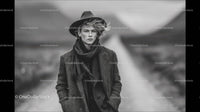 Fashionable Young Man in Herringbone Blazer with Scarf on Scenic Background