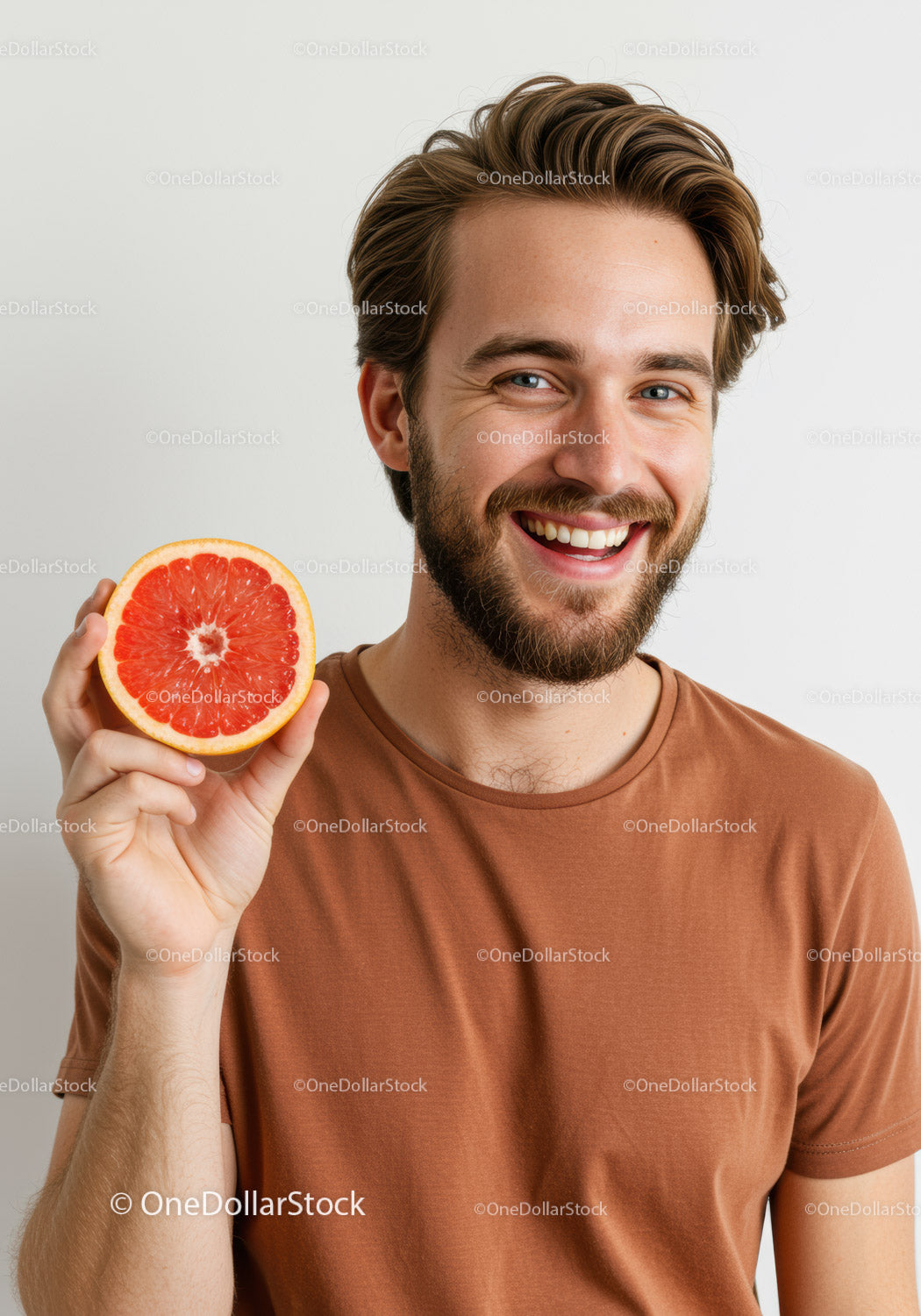 Smiling Man Holding Grapefruit in Casual Indoor Setting