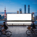 Evening cityscape with cyclists and large billboard by river