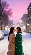 Couple sharing a tender kiss on snowy city street