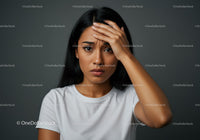 Stressed Woman Touching Forehead with Hand Expressing Frustration