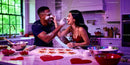 Couple Playfully Baking Heart-Shaped Cookies Together