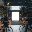 Urban night scene with blurred cyclists passing billboard