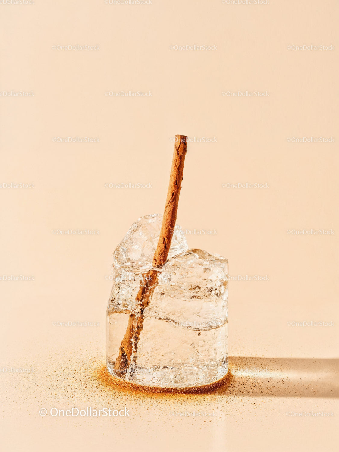 Closeup of cinnamon stick in melting ice cube