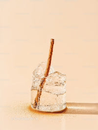 Closeup of cinnamon stick in melting ice cube
