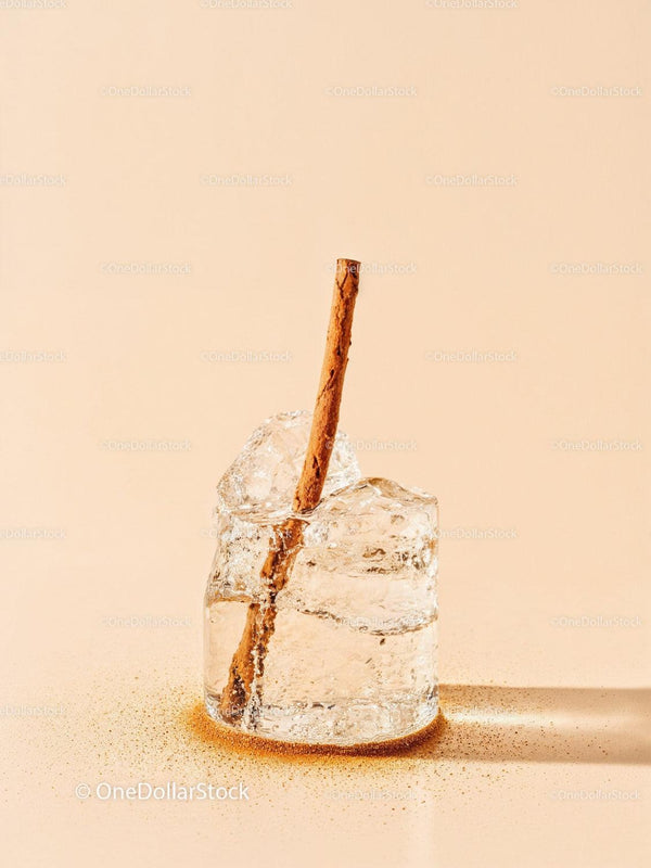 Closeup of cinnamon stick in melting ice cube