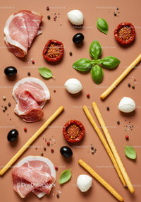 Italian antipasto ingredients on warm background